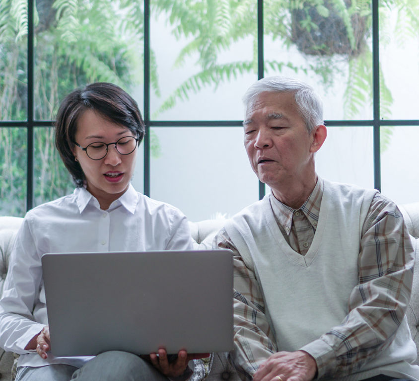 Asian senior couple consult and discuss health plan with woman doctor at home